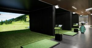 The interior of a golf simulator franchise, including three separate golfing simulators ready for customer use.